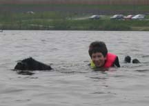 Picture of Black Newfoundland dog called Togan towing a young boy