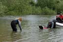 Picture of Landseer dog towing boat to within reach of owner on shore