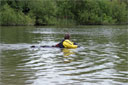 picture of brown newfoundland dog and owner starting controlled swim