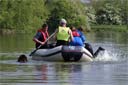 picture of rescued person being helped aboard boat whilst newfoundland swims round boat
