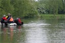 picture of black newfoundland dog leaving boat